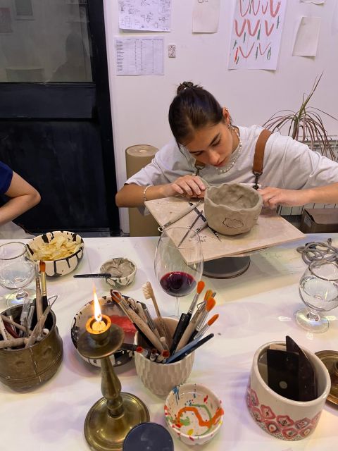 Wine & Pottery Class For Beginners in Buenos Aires Argentina - Decorating the piece before the studio finishes it